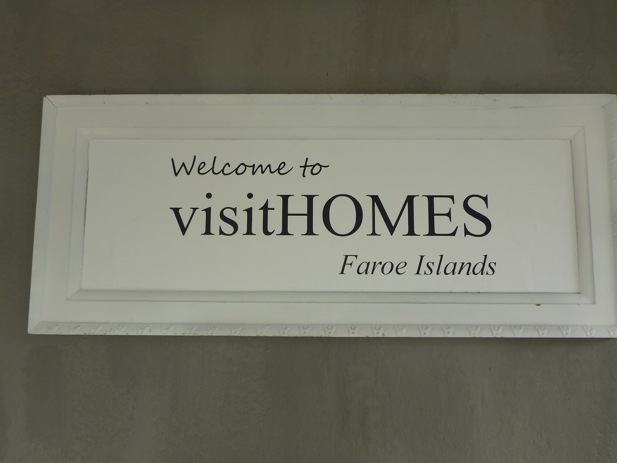 Logo at visitHOMES – The little corner single room in Leirvík