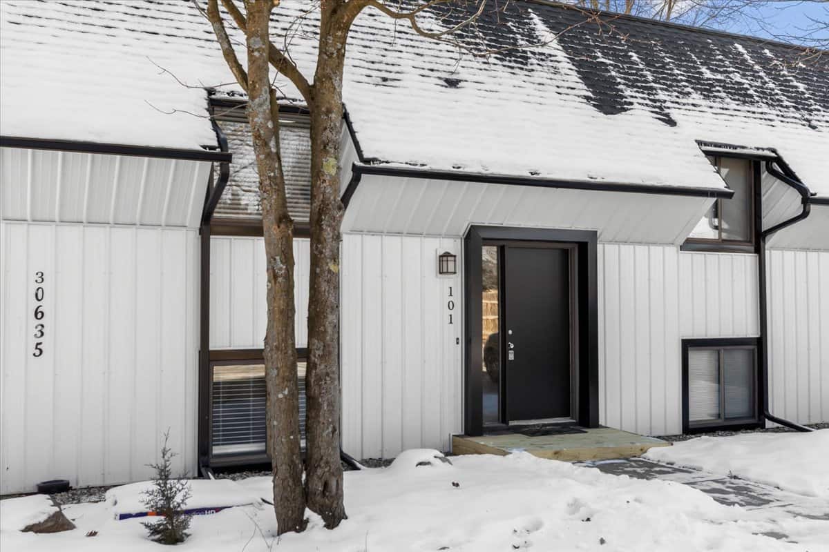 Snow-covered front entrance at Skyewest Townhomes in New Hudson