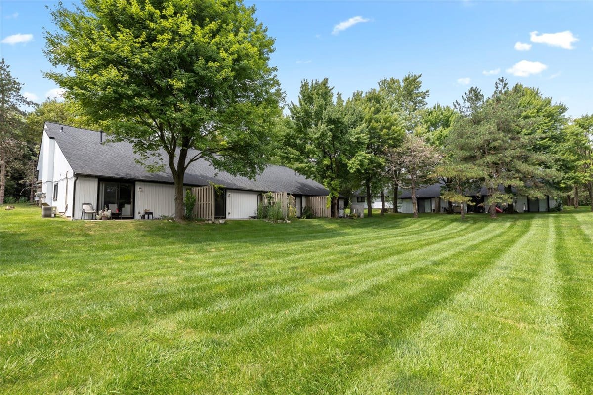 Expansive lawn and exterior view of Skyewest Townhomes in New Hudson
