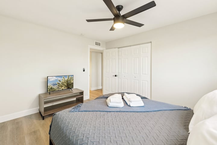 Very spacious bedroom with queen size bed, tv and large closet.