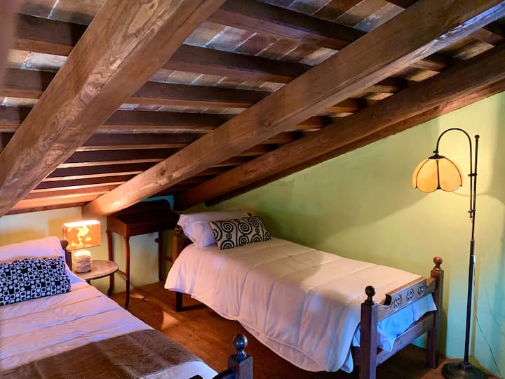 Голема четворокреветна соба со брачен кревет на едната страна и два единечни кревета на другата страна