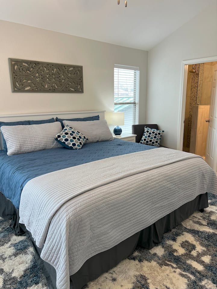King size bed in bedroom 1.  Walk in show with newly renovated bathroom with walk-in shower.  