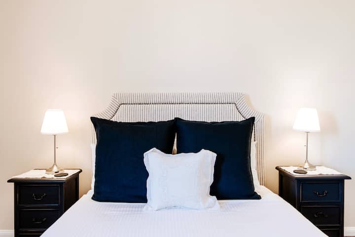 The gorgeous Celeste Room – Sink into luxury with a plush queen-size mattress, framed by a Canalside linen bedhead and elegant antique bedside tables. The private ensuite and built-in wardrobe ensure effortless comfort, making this retreat perfect.