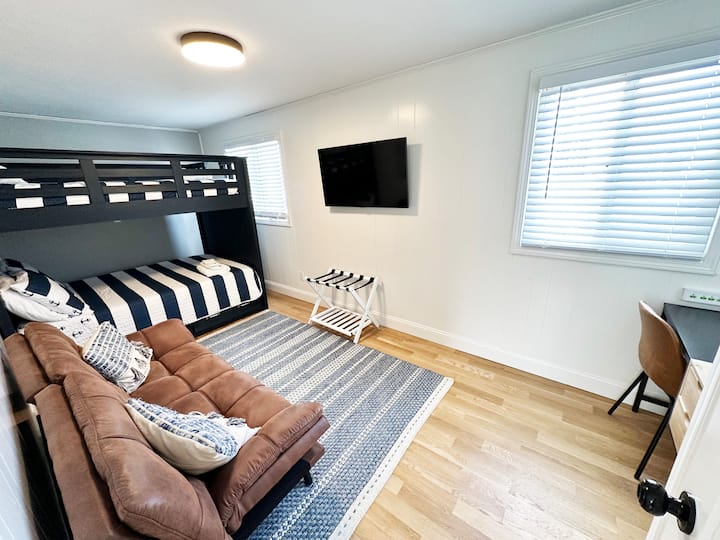 Spacious second bedroom with sofa and tv