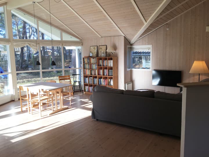 Sala de estar/sala familiar con mesa de comedor, sofá de esquina, TV y hermosas vistas al jardín.
Hay dos sillas altas para la mesa del comedor.
La mesa del comedor tiene 6 asientos y tiene registros adicionales.

