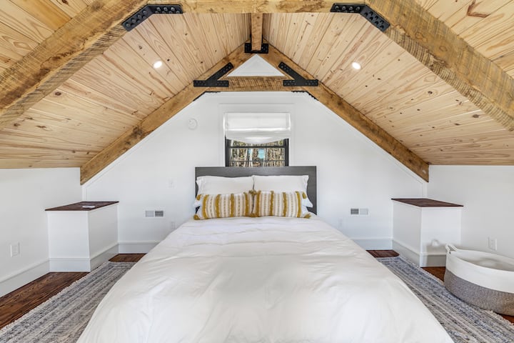 Upper loft sleeping area features a queen bed and wall mount fan. Please note-this upper loft area does not have a door.