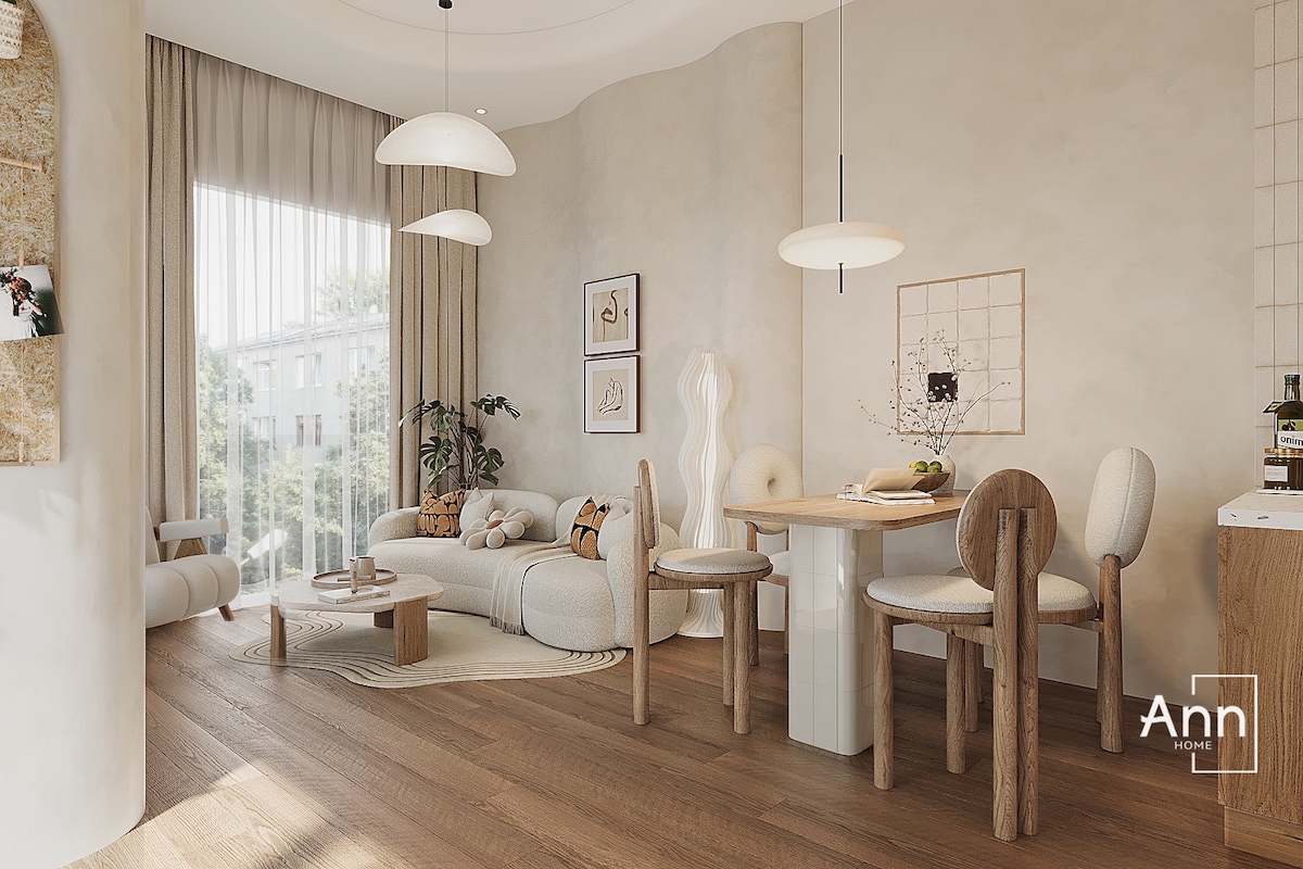 A bright and inviting living area features a light-colored sofa with cozy cushions, surrounded by a wooden dining table and matching chairs. Natural light filters through large windows, illuminating the space while indoor plants add a touch of greenery.