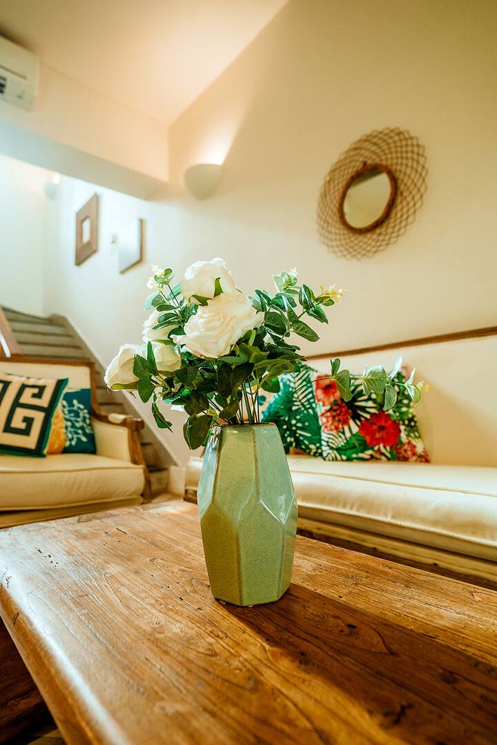 A delightful detail from our Goa villa: fresh flowers on a unique wooden coffee table, adding a touch of charm to your tropical getaway.