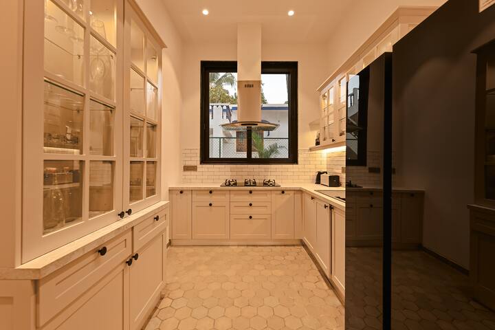 Modern Goa villa kitchen: fully equipped with sleek appliances and ample counter space, perfect for culinary adventures during your stay.