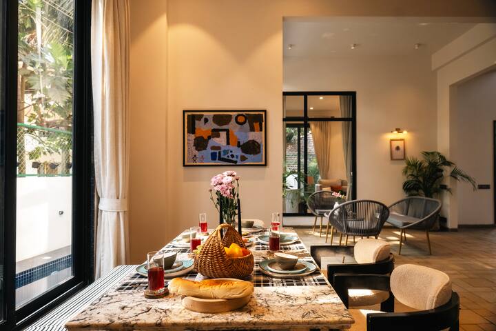 Enjoy delightful meals in this stylish Goa villa dining area, with a beautiful setup and ample space for memorable gatherings.