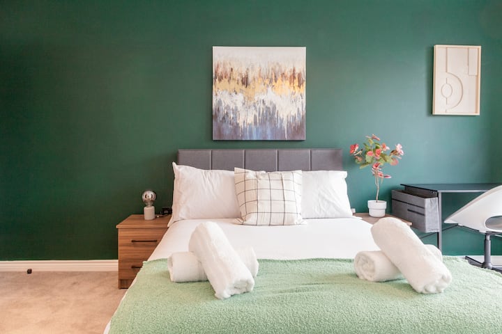 A stylish and comfortable bedroom with a soft double bed and a sleek wardrobe, perfect for a relaxing stay