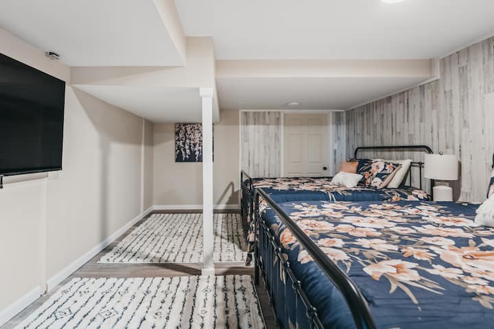 Spacious room with floral beds and a large TV, perfect for unwinding after fun-filled activities!
