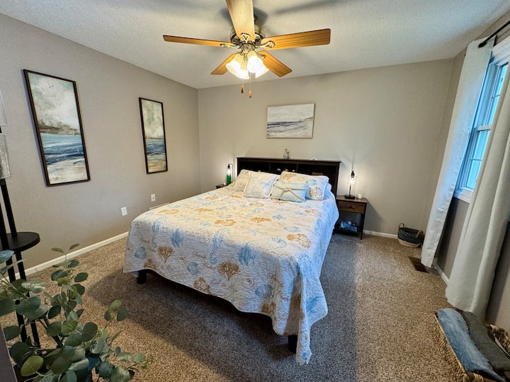 Embrace the beach vibe in the summer-themed bedroom, complete with a cozy queen-sized bed for ultimate relaxation.