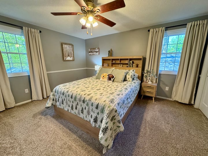 The master bedroom features a serene winter theme, complemented by a comfortable queen-sized bed for a restful night's sleep.