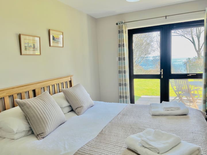 Master bedroom with ocean views and direct access to garden
