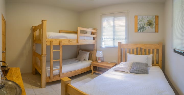 This cozy bedroom comfortably sleeps up to 6 guests, with a bunk bed and an additional full-size bed. Soft linens and comfy mattresses ensure a great night’s sleep after a day of adventure in Juayúa.
