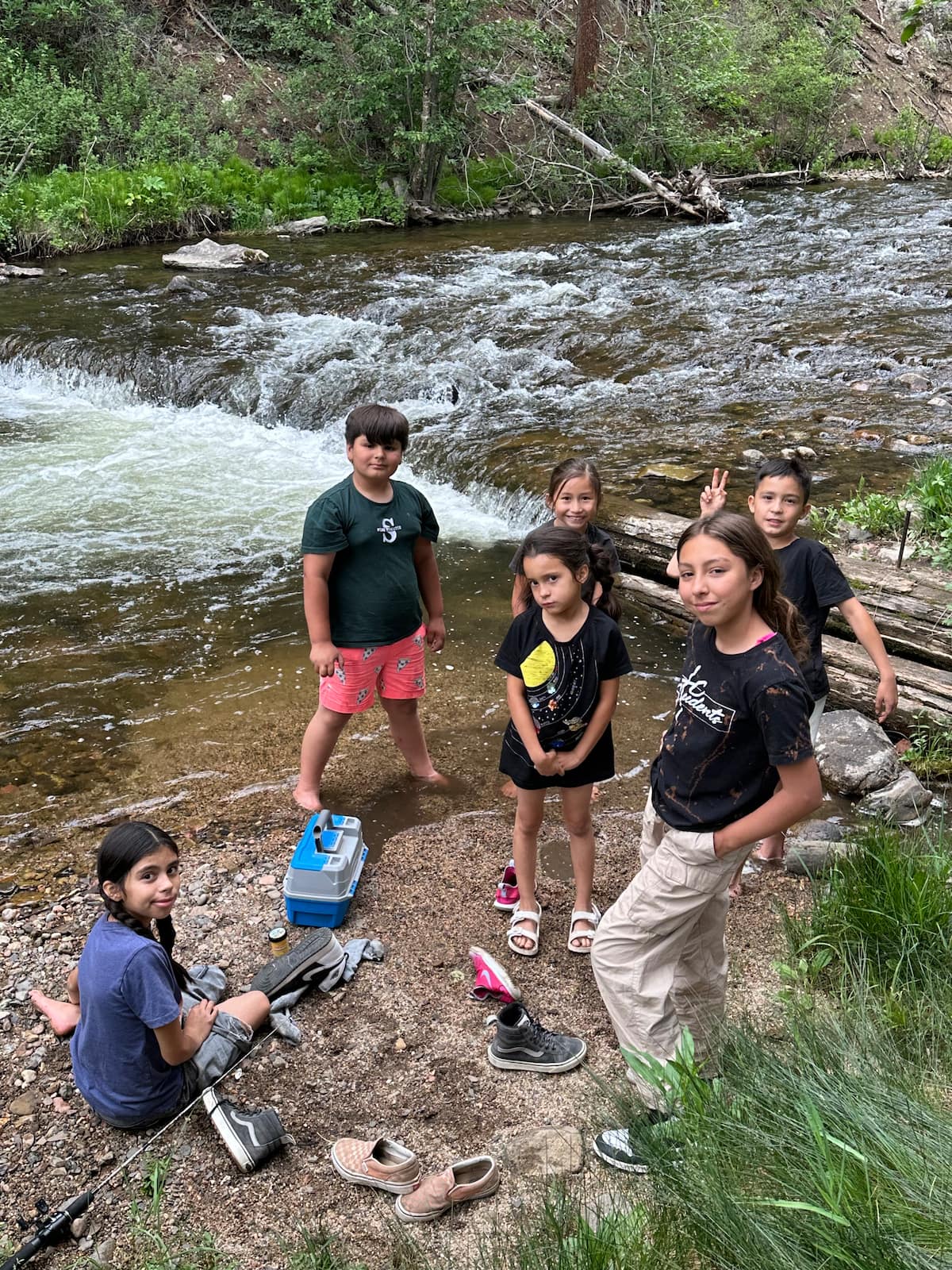 Children playing in the cold, clear Pecos River on a summer day
