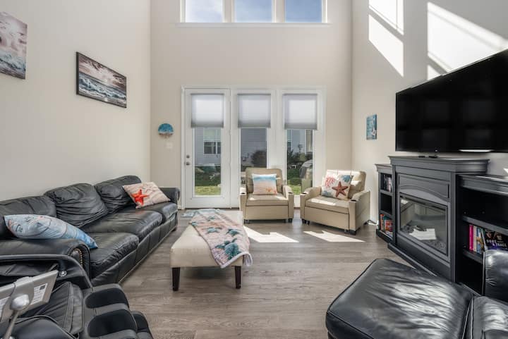 Enjoy a spacious and cozy living room with vaulted ceilings