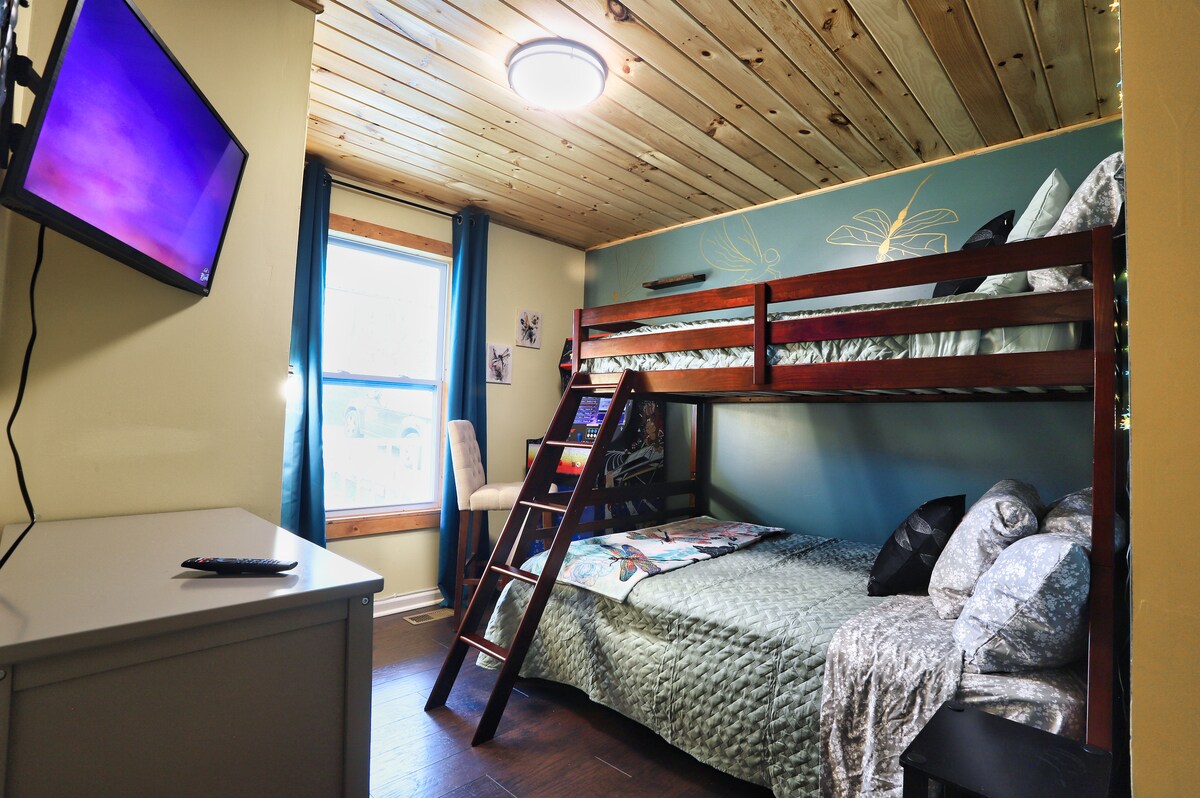 The bunk room has a twin over a full bunk bed with blackout curtains, a dresser, a closet, a TV, and a multicade! We did fun drawings of dragonflys on the walls too!