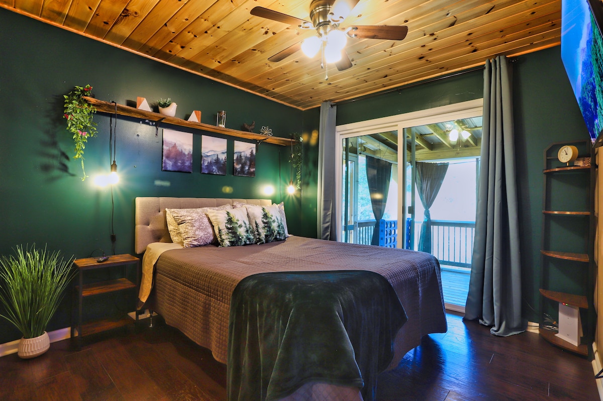 Our queen bedroom is off the back patio and has a TV, closet, and room-darkening shades to create comfort and relaxation. 