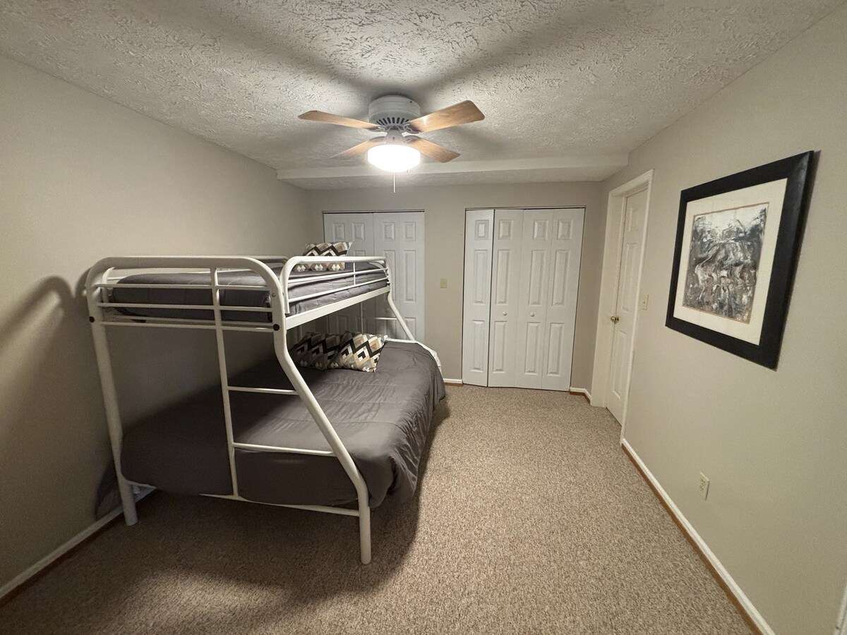 Druhá spálňa na dolnom poschodí s poschodovou posteľou s manželskou posteľou a vlastnou kúpeľňou so sprchovacím kútom