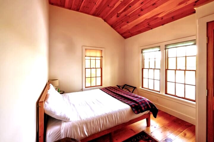 Bedroom looking out over the lake. Loons will sing you to sleep at night.