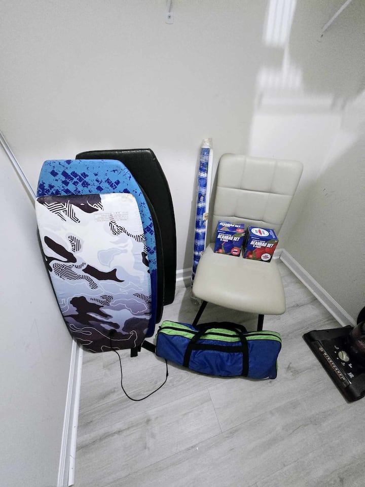 Sombrilla, tablas de bodyboard y bolsas de maíz en el armario principal