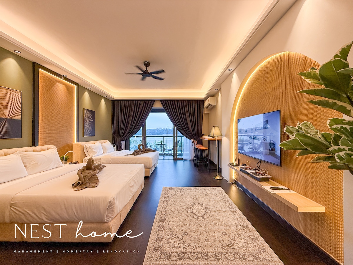 A spacious studio suite is presented with two premium queen beds and stylish decor, featuring soothing neutral tones. A large window offers a view of the private balcony, and a smart TV is mounted on a wooden wall unit. Soft lighting enhances the modern ambience.