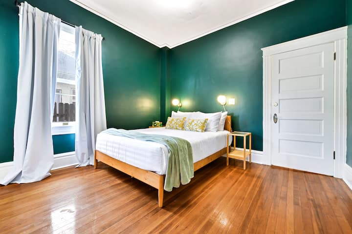 Golden light meets forest green: an inviting nook where bold color and soft comfort embrace.