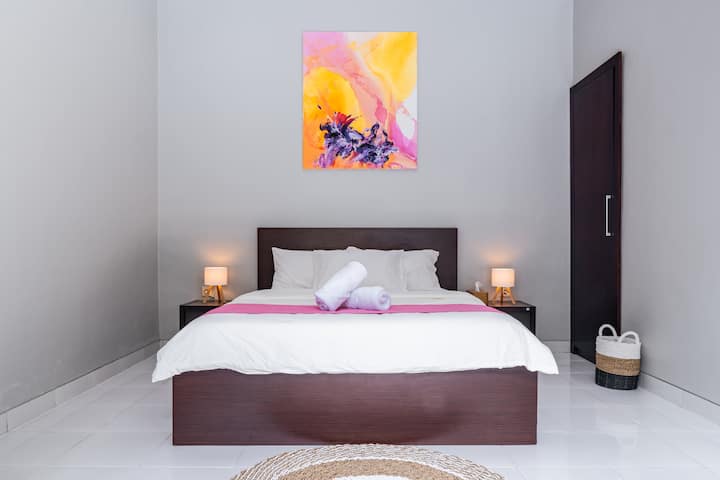 Queen bedroom with closet and bedside lamps