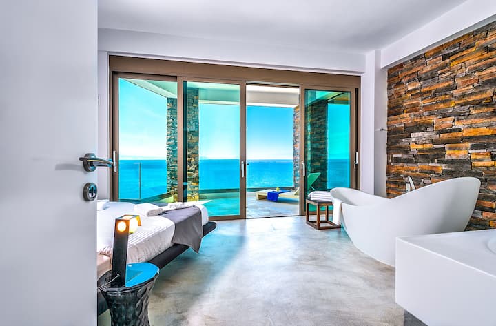 First Floor: Bedroom 2 with double bed, freestanding bathtub, terrace access