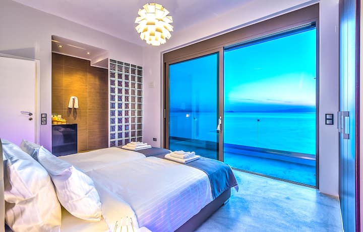 First Floor: Bedroom 3 with twin beds, en-suite with feature glass-brick shower, terrace access