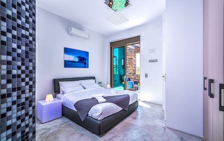 First Floor: Bedroom 4 with king-size bed, en-suite with snail-style wellness shower, access to private patio