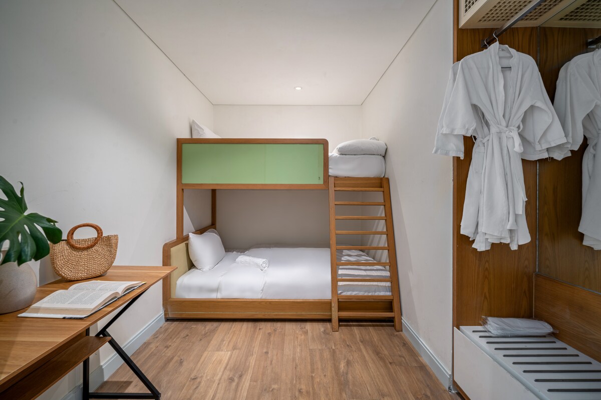 Оваа удобна втора спална соба е внимателно уредена со кревет на спрат, биро за пишување и гардероба — идеални за деца или дополнителни гости.