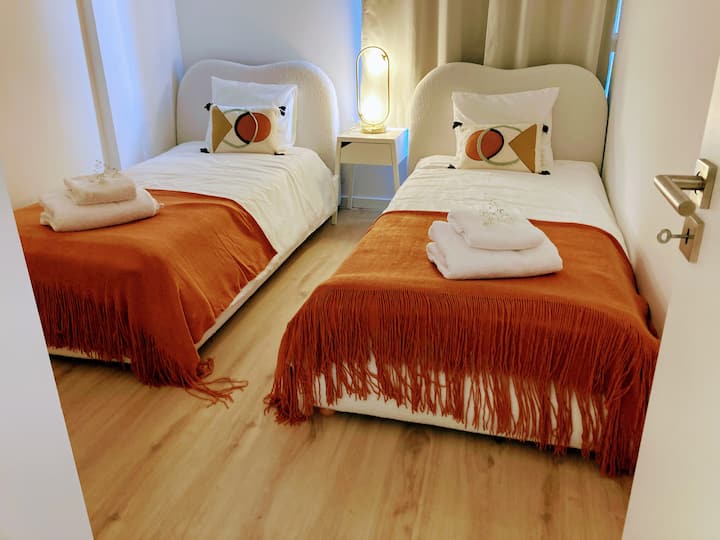 2 Single Beds, Air Conditioning, Clothing Cabinet, Hangers, Blankets and Extra Cushions, Bed Clothes, Bath Towels, Dark Curtains and Wifi.