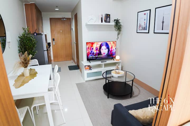 Our living room is decorated with famous Toronto landmarks and features a comfy sofa, a sleek coffee table, a 43” Google 2K FHD TV, and a selection of board and card games—perfect for a relaxing night in!