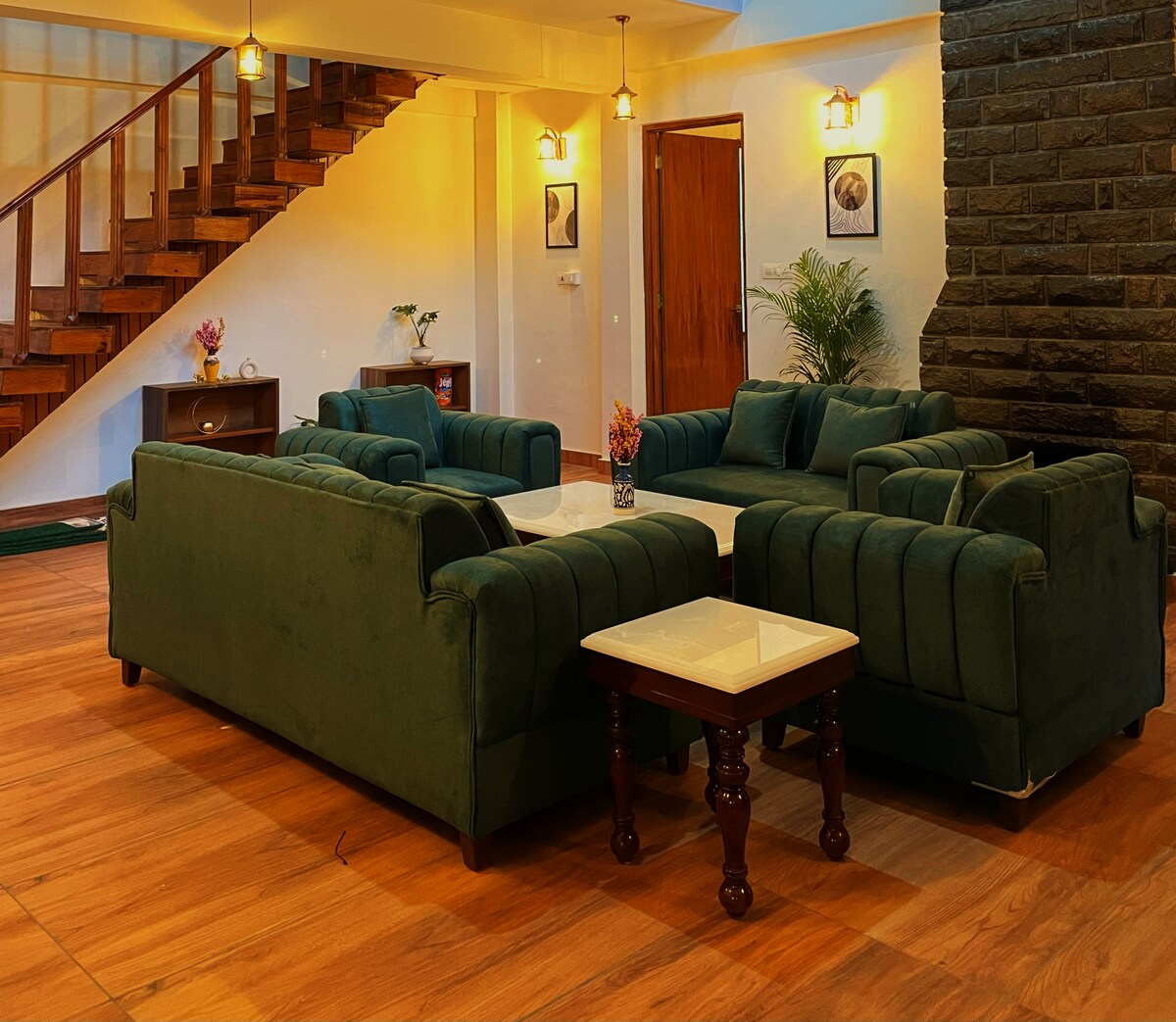 The lounge — stone walls, warm light, wooden staircase