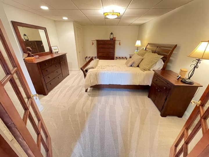 Este dormitorio de nivel inferior está justo al lado de la sala de la mesa del parachoques y cuenta con una cama tamaño queen con un colchón Tempur-Pedic. Los cajones forrados de cedro y las perchas de ropa de cedro le dan a este dormitorio un ambiente acogedor de casa de campo. 