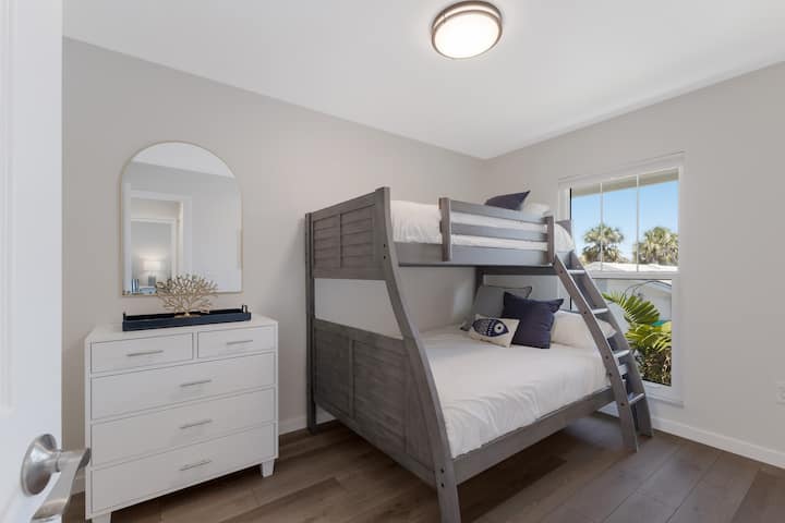 Second bedroom with dresser and bunk beds.