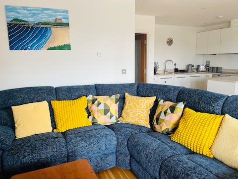 Corner sofa in the living area with yellow cushions