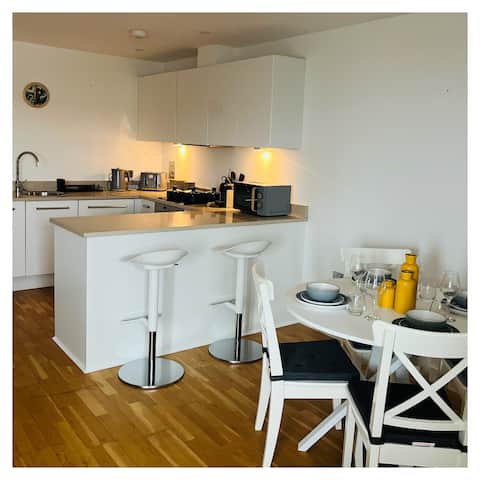 Open plan kitchen with breakfast bar and stools