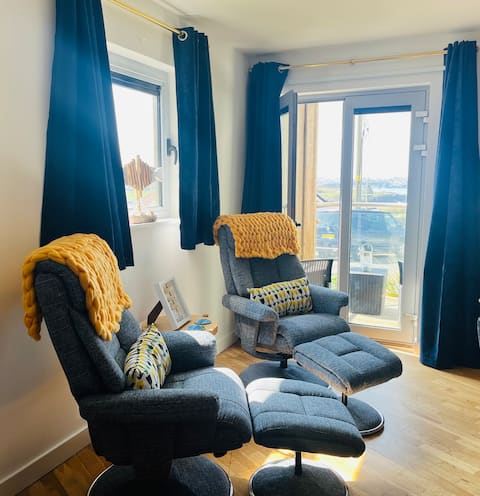 Recliner chairs facing the balcony windows
