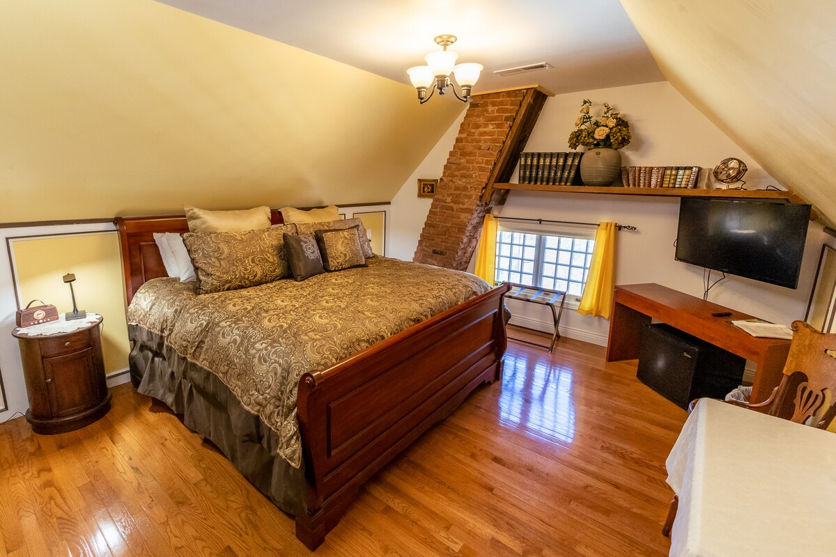 The king bed has bedside tables with lamps that have built-in USB charging. The television is internet-connected with access to streaming apps. High-speed wifi is available throughout the house. 