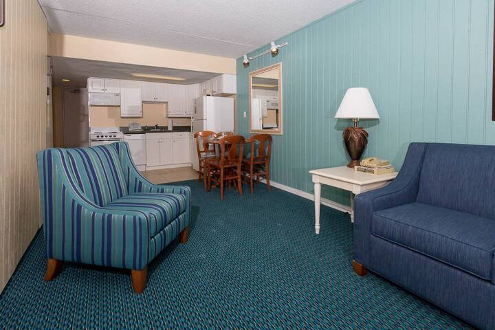 A stylish sofa bed placed in the living room offers a perfect blend of comfort and convenience, creating a warm and welcoming space for guests to relax, unwind, and enjoy their stay with ease daily u.