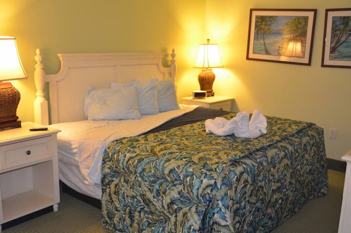A cozy queen bed sits beautifully in this calm bedroom, offering comfort, warmth, and a relaxing atmosphere where guests can unwind, rest peacefully, and enjoy a refreshing stay throughout their visit.