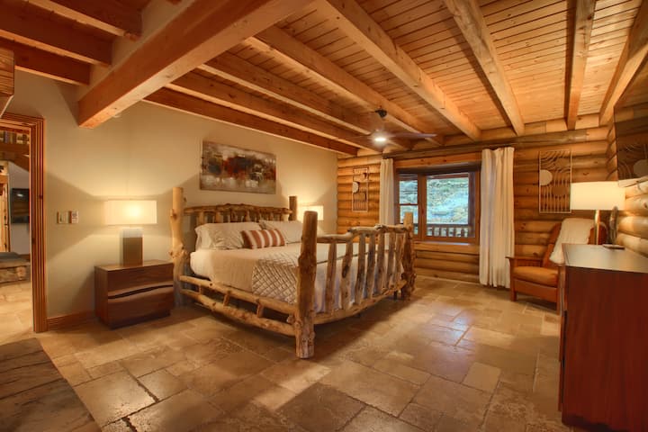 Cozy bedroom with a wooden bed frame and a serene atmosphere.