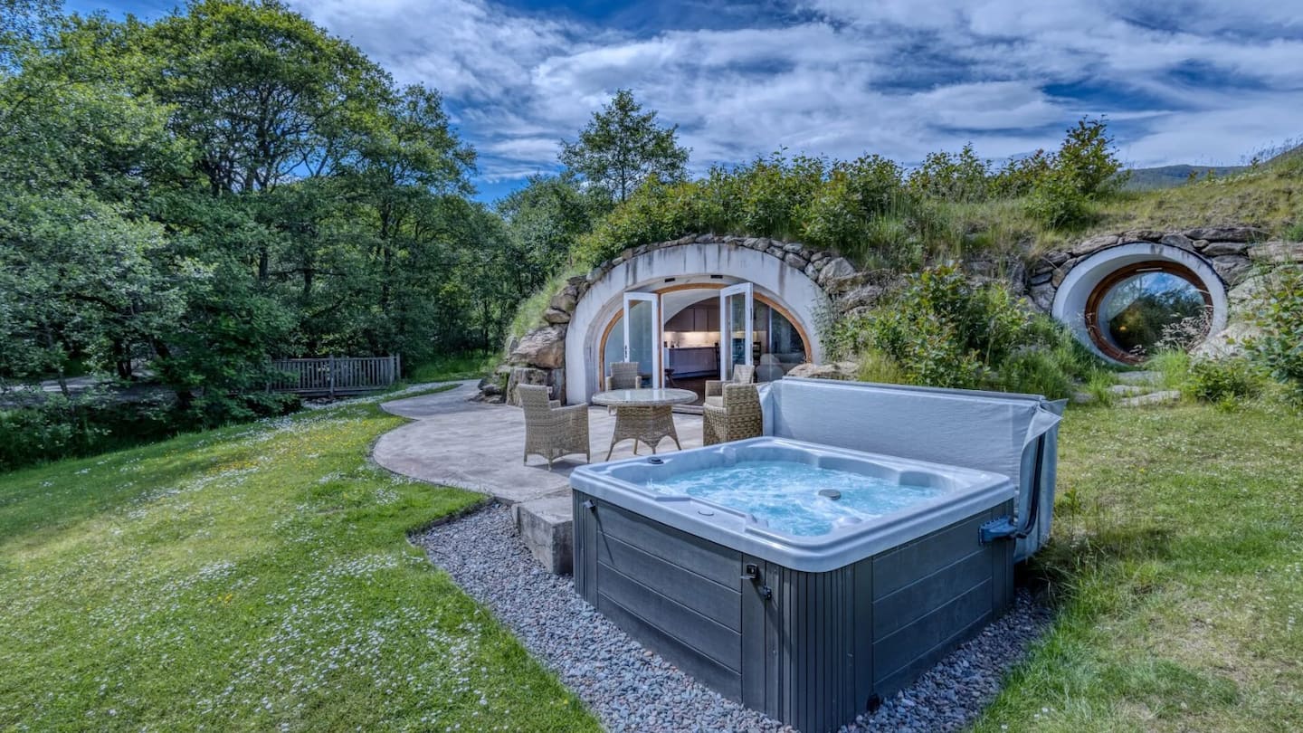 The Warren underground hobbit house with grass roof set into a hillside at Loch Tay