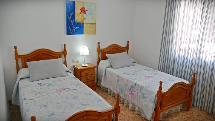 Chambre avec deux lits simples de 90 cm de large. Dans cette chambre il y a une armoire et il dispose de sa propre unité de climatisation. Fenêtre sur la rue principale.