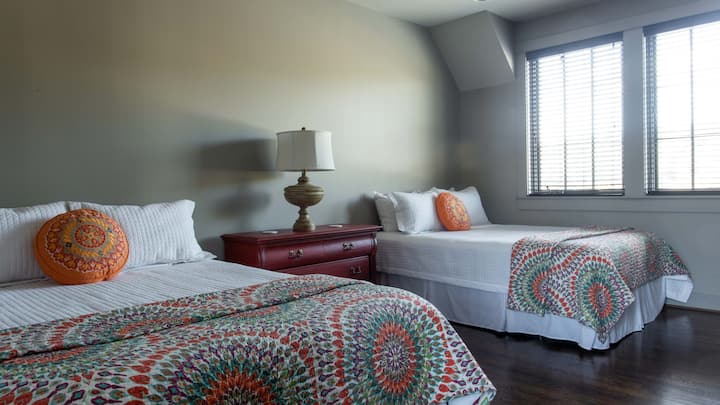 Upstairs bedroom #1 with two queen beds. This has a jack and Jill bathroom with its own shower, toilet and dual vanities.
