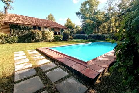 House with a pool and wooded park